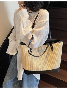 French style straw tote bag with black leather trim and handles for summer commute