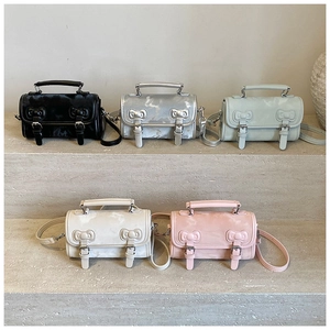 Collection of five colorful mini crossbody bags with bow details and marble texture