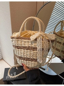 Handmade straw bucket bag with striped pattern, lace bow, and drawstring liner for women