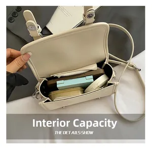 Internal capacity of the cream crossbody bag showing phone and makeup accessories