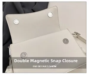 Detail view of the secure double magnetic buckle closure on a beige pleated cloud bag