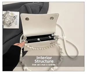 Internal view showing main pocket and zipper compartment of white pleated cloud bag