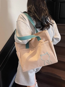 Large beige canvas tote bag with green straps and cat silhouette embroidery