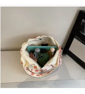 Interior view of large canvas tote bag showing storage for tablet, phone and umbrella