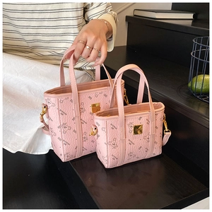 Pink crossbody bucket bag set featuring cartoon bear prints and golden logo details