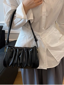 Minimalist black glossy ruched cloud shoulder bag with wave texture and thin strap