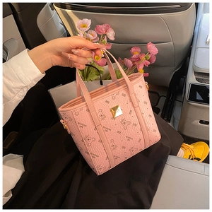 Detail of pink leather tote bag featuring cute bear prints and a gold metal buckle