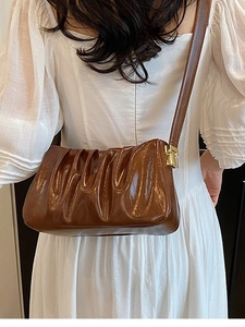 Brown ruched cloud bag in glossy PU leather with gold hardware for a retro shoulder look