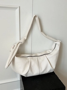 Chic creamy white pleated croissant bag with knotted shoulder strap and lychee texture