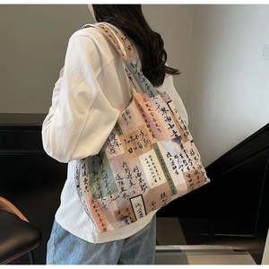 Detail of the oversized canvas tote bag with artistic Chinese calligraphy and floral patterns