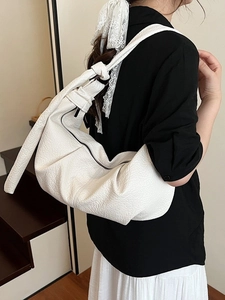Chic beige ruched hobo bag in soft pleated leather, stylish crossbody bag for women