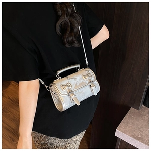 Detail of silver metallic handbag showing smooth PU texture and decorative buckle straps