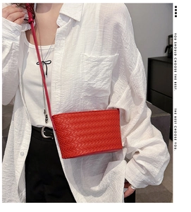 Detail view of the intricate red woven leather texture on this stylish crossbody bag