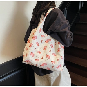 Macro detail of canvas tote bag featuring pink koi fish print and oriental pattern