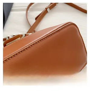 Close-up of caramel leather handbag featuring uniform stitching and high-quality texture
