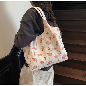 Detailed macro view of waffle texture canvas and koi fish floral print on tote bag