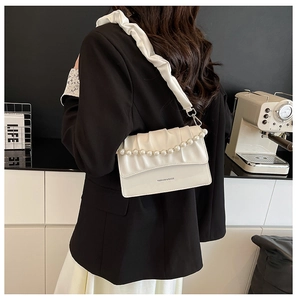 Detail of white pleated cloud bag with pearl chain and fashion letter print