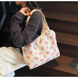 Macro detail of the textured waffle fabric bag with pink koi print and soft texture