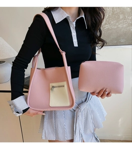 Detail of pink lychee textured shoulder bag with contrast cream pocket and matching pouch
