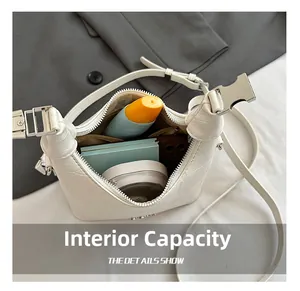 Internal capacity of white crocodile embossed crossbody bag showing daily essentials