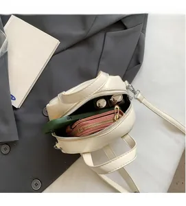 Interior view of white minimalist pillow bag showing capacity for phone and makeup