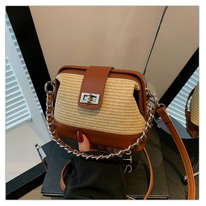 Close-up of a woven shell-shaped bag with brown leather trim and silver twist lock