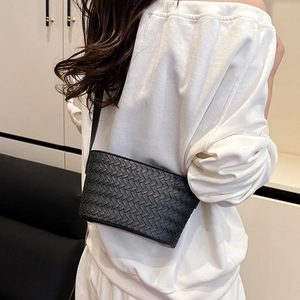 Detail view of the black hand-woven leather texture on this stylish small square crossbody bag