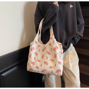 Detail of white canvas tote bag with red goldfish print and traditional Chinese character