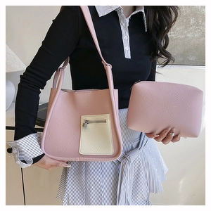 Pink lychee texture shoulder bag with small pouch detail showing cross-body strap