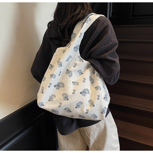 Detail of canvas tote bag showing the blue koi carp pattern and koi calligraphy print