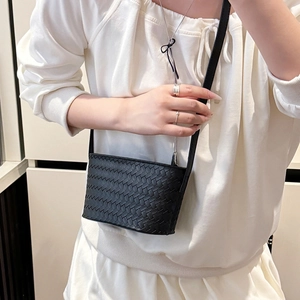 Close-up of black woven leather mini square bag showing the Intrecciato craft texture