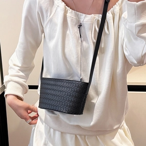 Detailed view of black woven leather crossbody bag with classic Intrecciato texture