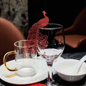 Red peacock laser-cut paper wine glass place cards for festive wedding table decor