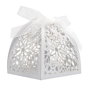 Detailed view of white laser-cut floral wedding candy box with elegant organza ribbon bow