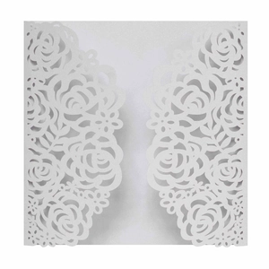Close-up of laser-cut ivory rose wedding invitation featuring intricate floral details