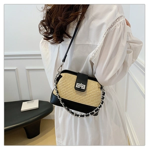 Detail of hand-woven shell bag featuring black leather trim and silver metal chain strap