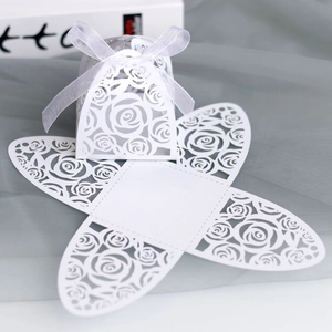 Laser-cut white rose gift box detail with pearl paper texture and white silk ribbon bow