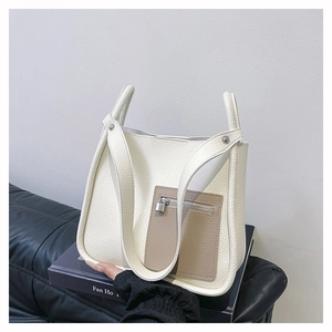Detail of lychee pattern leather tote bag with contrasting outer pocket and hardware
