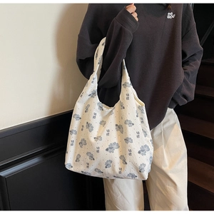 Detail of white waffle fabric tote bag featuring blue koi fish print and oriental pattern