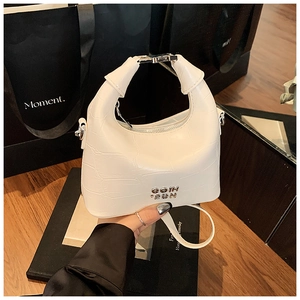 Detail of white crocodile pattern crescent bag with silver buckle and metal logo