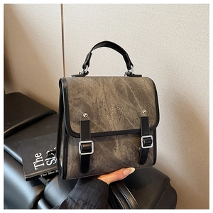 Close-up of the vintage grey canvas backpack with enjoy chan 2875 embossed lettering
