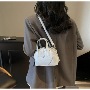 Rear view of a white heart-stitched Boston bag styled with a grey oversized blazer