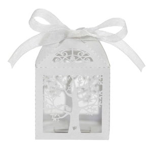 Detail of white laser-cut hollow tree design on paper candy box with silk ribbon bow