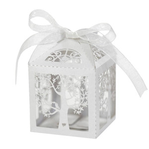 Detailed laser-cut tree and bird patterns on white paper candy box with ribbon