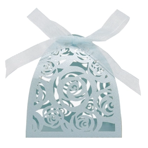 Detail of light blue laser-cut rose candy box with a silk bow for wedding and parties