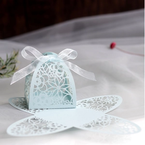 Detail of light blue hollow flower candy box with white ribbon for wedding party favors