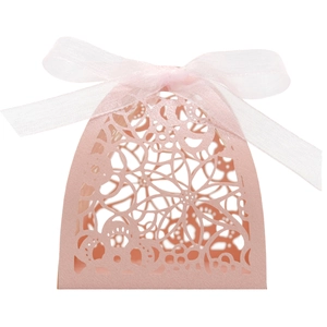 Detailed laser-cut floral patterns on pink gift box with a large sheer ribbon bow