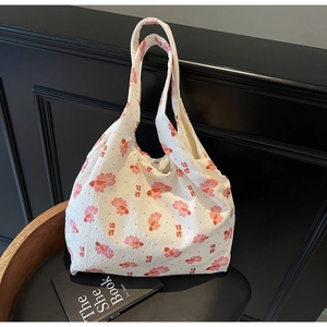Close-up of fabric texture and koi fish embroidery on white tote bag with calligraphy