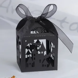 Detail of laser-cut black Halloween candy box with castle, bat and spider patterns