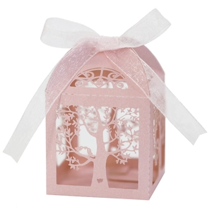 Close-up of pink laser-cut favor box with tree branch pattern and white ribbon bow